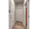 Hallway with white doors, wood-look flooring, and access to a garage, promoting practicality at 1019 Laconic Dr., Myrtle Beach, SC 29588