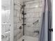Bathroom shower featuring marble-style tile, grab bar and convenient corner shelves at 10301 N Kings Hwy. # 10-4, Myrtle Beach, SC 29572