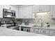 Bright kitchen features stainless steel appliances, white cabinets, and lovely marble countertops at 10301 N Kings Hwy. # 10-4, Myrtle Beach, SC 29572