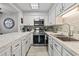 Charming kitchen with stainless steel appliances, white cabinets, and lovely marble countertops at 10301 N Kings Hwy. # 10-4, Myrtle Beach, SC 29572