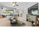Bright living room with a large TV, comfortable seating, and access to the balcony through sliding glass doors at 10301 N Kings Hwy. # 10-4, Myrtle Beach, SC 29572