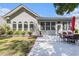 Charming home exterior featuring a patio with dining set, manicured lawn, and lush garden at 1105 Lampwick Ln., Murrells Inlet, SC 29576
