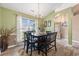 Dining room with hardwood floors, large window with sheer curtains, and chandelier lighting at 1105 Lampwick Ln., Murrells Inlet, SC 29576