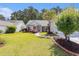 Single-Gathering home featuring lush landscaping, palm trees, and a charming walkway at 1105 Lampwick Ln., Murrells Inlet, SC 29576