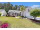Charming single-Gathering home with lush green lawn, manicured landscaping and a driveway at 1105 Lampwick Ln., Murrells Inlet, SC 29576