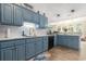 Kitchen featuring blue cabinets, stainless appliances, and wood flooring at 1105 Lampwick Ln., Murrells Inlet, SC 29576