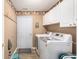 Functional laundry area features modern washer and dryer, ample storage, and convenient hanging hooks at 1105 Lampwick Ln., Murrells Inlet, SC 29576