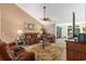 Comfortable living room with wood floors, large rug, and access to outdoor sunroom at 1105 Lampwick Ln., Murrells Inlet, SC 29576
