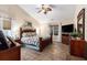 Spacious main bedroom with wood floors, ceiling fan, and multiple windows at 1105 Lampwick Ln., Murrells Inlet, SC 29576