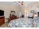 A spacious main bedroom with high ceilings, a ceiling fan, and a beautiful quilt on the bed at 1105 Lampwick Ln., Murrells Inlet, SC 29576