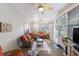 Bright sunroom with comfortable seating, ceiling fans, and views of the outdoors at 1105 Lampwick Ln., Murrells Inlet, SC 29576