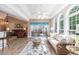 Bright sunroom with lots of natural light, wood floors, and neutral-toned coastal decor at 1105 Lampwick Ln., Murrells Inlet, SC 29576