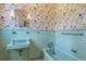 Classic bathroom features a sink, and a bathtub with vintage wallpaper at 115 Ford Ave, Mullins, SC 29574
