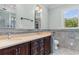 Bathroom with dual vanity and tiled walls at 115 Ford Ave, Mullins, SC 29574
