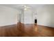 Spacious bedroom with hardwood floors, ceiling fan, and doors to bathroom at 115 Ford Ave, Mullins, SC 29574