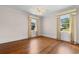 Bedroom featuring two windows with attractive curtains and hardwood flooring at 115 Ford Ave, Mullins, SC 29574