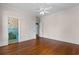 Bedroom features hardwood flooring and doors leading to a bathroom at 115 Ford Ave, Mullins, SC 29574