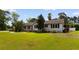View of the right side of a charming home with lush lawn and various landscaping details at 115 Ford Ave, Mullins, SC 29574