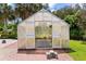 A well-lit greenhouse with metal flooring, shelving, and an open door for ventilation at 115 Ford Ave, Mullins, SC 29574