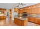 Spacious kitchen with custom wood cabinets, stainless steel appliances, tile backsplash, and marble-top island at 115 Ford Ave, Mullins, SC 29574