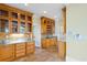 A kitchen with tiled floors, built-in cabinets with glass fronts, and stainless steel appliances at 115 Ford Ave, Mullins, SC 29574
