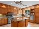 Well-lit kitchen with custom wood cabinets, tile backsplash, stainless steel appliances, and marble-top island at 115 Ford Ave, Mullins, SC 29574