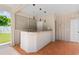 A covered outdoor bar area with a stainless steel countertop and access to the backyard at 115 Ford Ave, Mullins, SC 29574