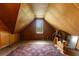 Cozy attic space with natural light from the window, offering potential for a unique living area at 118 Ford Ave, Mullins, SC 29574