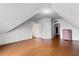 Attic space with hardwood floors, paneled walls, and multiple doorways at 118 Ford Ave, Mullins, SC 29574