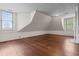 Attic space with hardwood floors, dormer windows, paneled walls, and natural light at 118 Ford Ave, Mullins, SC 29574