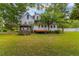 Expansive backyard with a charming gazebo, a wooden deck, and plenty of green space at 118 Ford Ave, Mullins, SC 29574