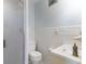 Bathroom with classic white tile, glass shower, and vintage fixtures at 118 Ford Ave, Mullins, SC 29574