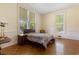 Bedroom with parquet floors, three windows, and neutral colored walls at 118 Ford Ave, Mullins, SC 29574