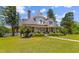 Stately two-story home with inviting front porch and manicured landscaping at 118 Ford Ave, Mullins, SC 29574