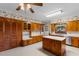 Bright kitchen featuring wood cabinets, center island, spacious counters, and pantry cabinets at 118 Ford Ave, Mullins, SC 29574