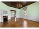 Well-lit living room with a fireplace, wood floors, large window and view to other room at 118 Ford Ave, Mullins, SC 29574
