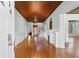 Open living room with hardwood floors, wainscoting, wood ceiling, chandelier and fireplace at 118 Ford Ave, Mullins, SC 29574
