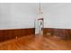 Traditional living room with hardwood floors, wood paneling, and open doorway at 118 Ford Ave, Mullins, SC 29574