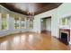 Bright living room boasting wood floors, and a fireplace with large windows and natural light at 118 Ford Ave, Mullins, SC 29574