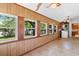 Bright sunroom with wood paneling, lots of windows, and adjacent laundry room at 118 Ford Ave, Mullins, SC 29574