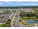 Aerial view of a condo complex near the water, featuring a scenic pond and mature trees at 1356 Glenns Bay Rd. # 202H, Myrtle Beach, SC 29575