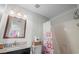 This bathroom features a single sink vanity with granite countertops, a mirror, and a shower at 1356 Glenns Bay Rd. # 202H, Myrtle Beach, SC 29575
