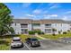 Exterior view of a two-story condo building with a parking lot in front at 1356 Glenns Bay Rd. # 202H, Myrtle Beach, SC 29575