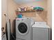 Laundry room with stacked washer and dryer and wire shelving at 1356 Glenns Bay Rd. # 202H, Myrtle Beach, SC 29575