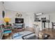 Open-concept living area with modern furniture, hardwood floors, and a view of the adjacent kitchen at 1356 Glenns Bay Rd. # 202H, Myrtle Beach, SC 29575