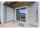 Exterior view of a patio with sliding glass doors and gray vinyl siding at 1356 Glenns Bay Rd. # 202H, Myrtle Beach, SC 29575