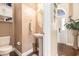 Cozy powder room with pedestal sink, decorative mirror, and stylish fixtures at 1367 Bermuda Grass Dr., Myrtle Beach, SC 29579