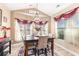Dining area featuring a modern chandelier, natural light, and a decorative area rug at 1367 Bermuda Grass Dr., Myrtle Beach, SC 29579