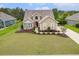 Charming home featuring a manicured lawn, mature trees, and a welcoming red front door at 1367 Bermuda Grass Dr., Myrtle Beach, SC 29579