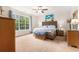 Serene main bedroom featuring a large window with a view, a ceiling fan, and neutral decor at 1367 Bermuda Grass Dr., Myrtle Beach, SC 29579
